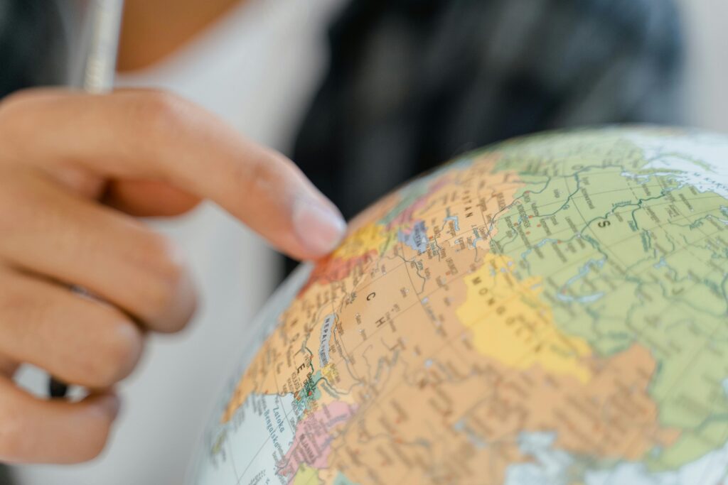 a man pointing finger on a globe 